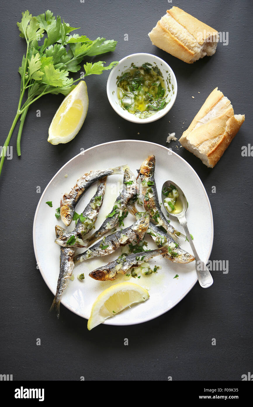 Grilled sardine with salsa verde on a plate.Top view Stock Photo Alamy