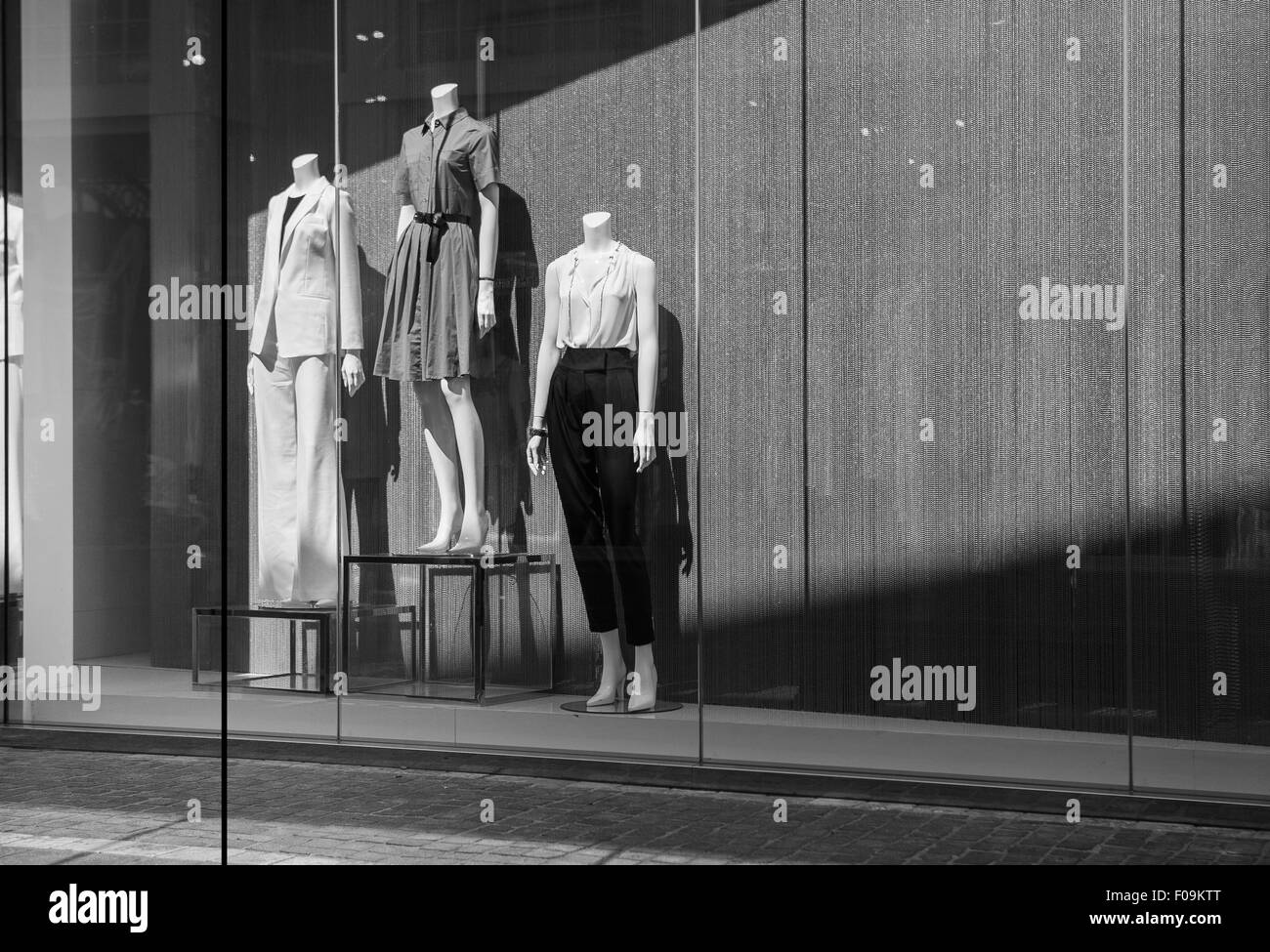 Boutique display window with mannequins in fashionable dresses Stock Photo