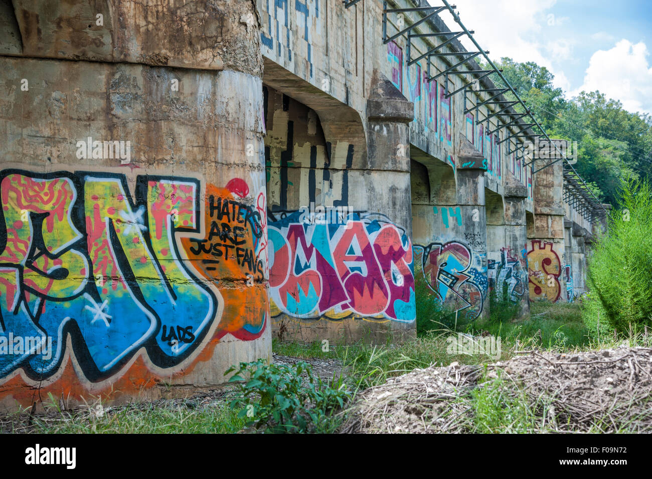 Graffiti covered supports on an old bridge in Asheville, North Carolina's River Arts District. USA. Stock Photo