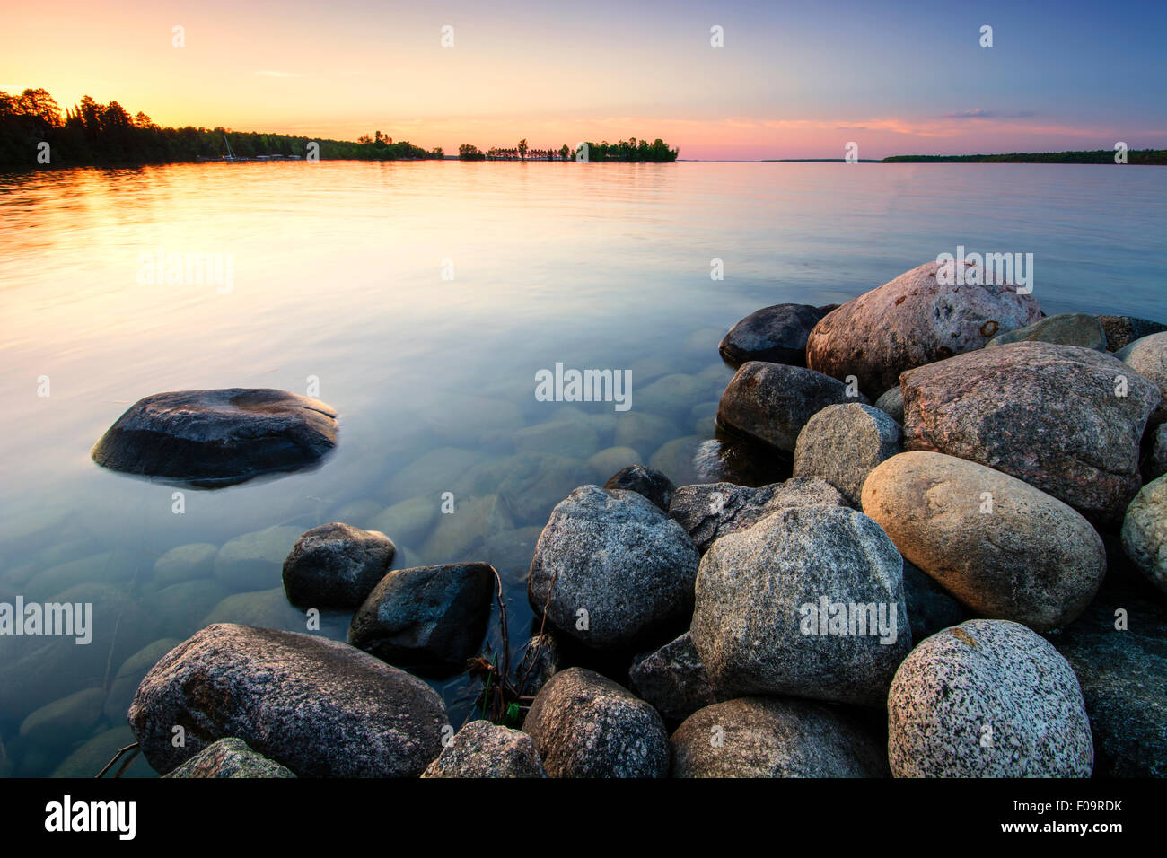 Large boulders on lake shore at sunset. Minnesota, USA Stock Photo