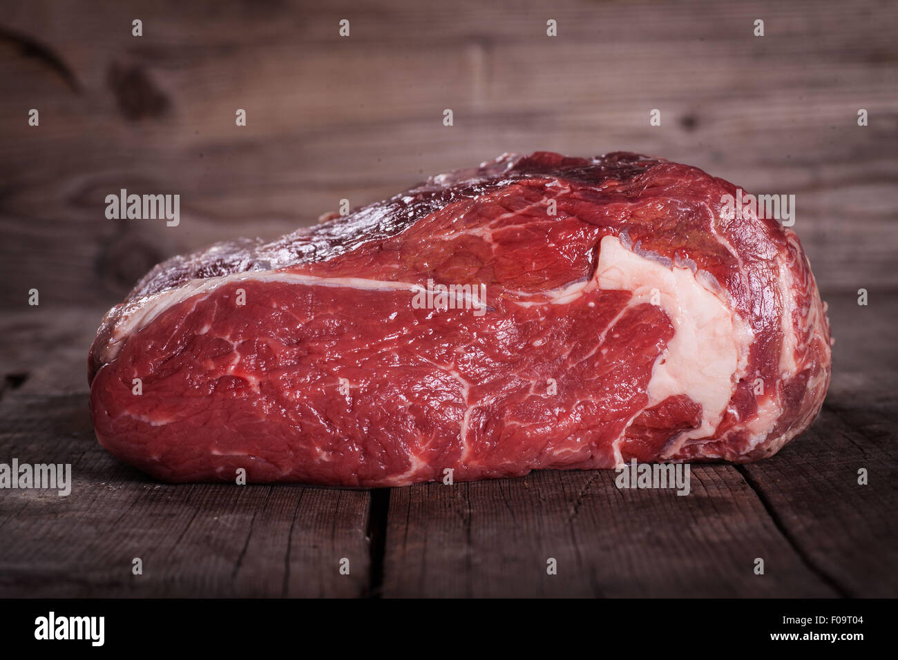 Beef on wooden table over wooden background Stock Photo