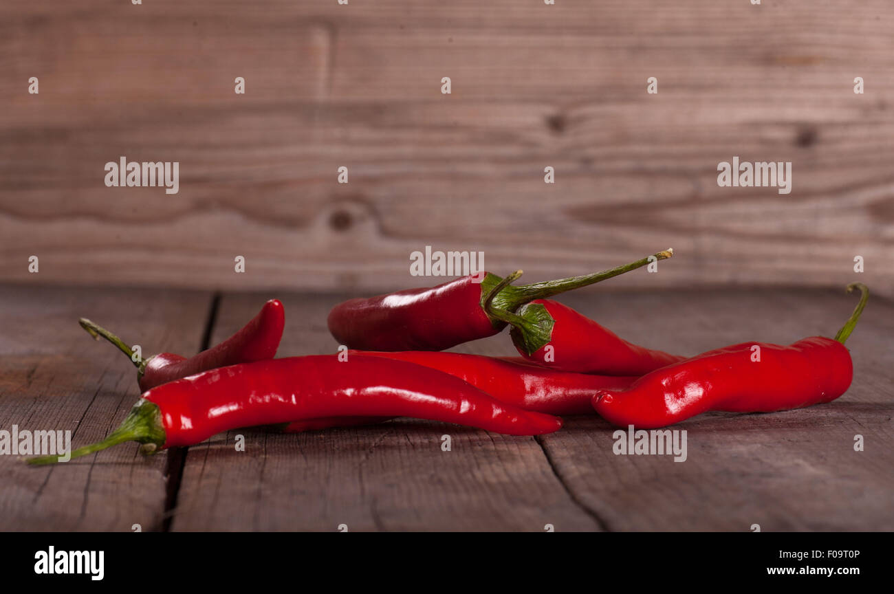 Hot Chilli Pepper on wooden table Stock Photo - Alamy