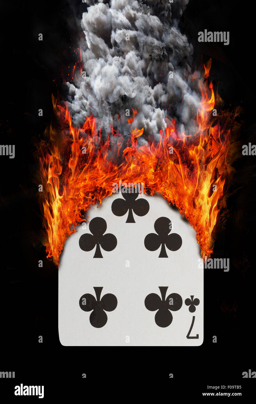 Playing card with fire and smoke, Seven of clubs Stock Photo