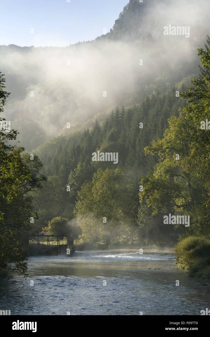 View of Loue river with fog near the village of Lods, Franche-Comte, France Stock Photo