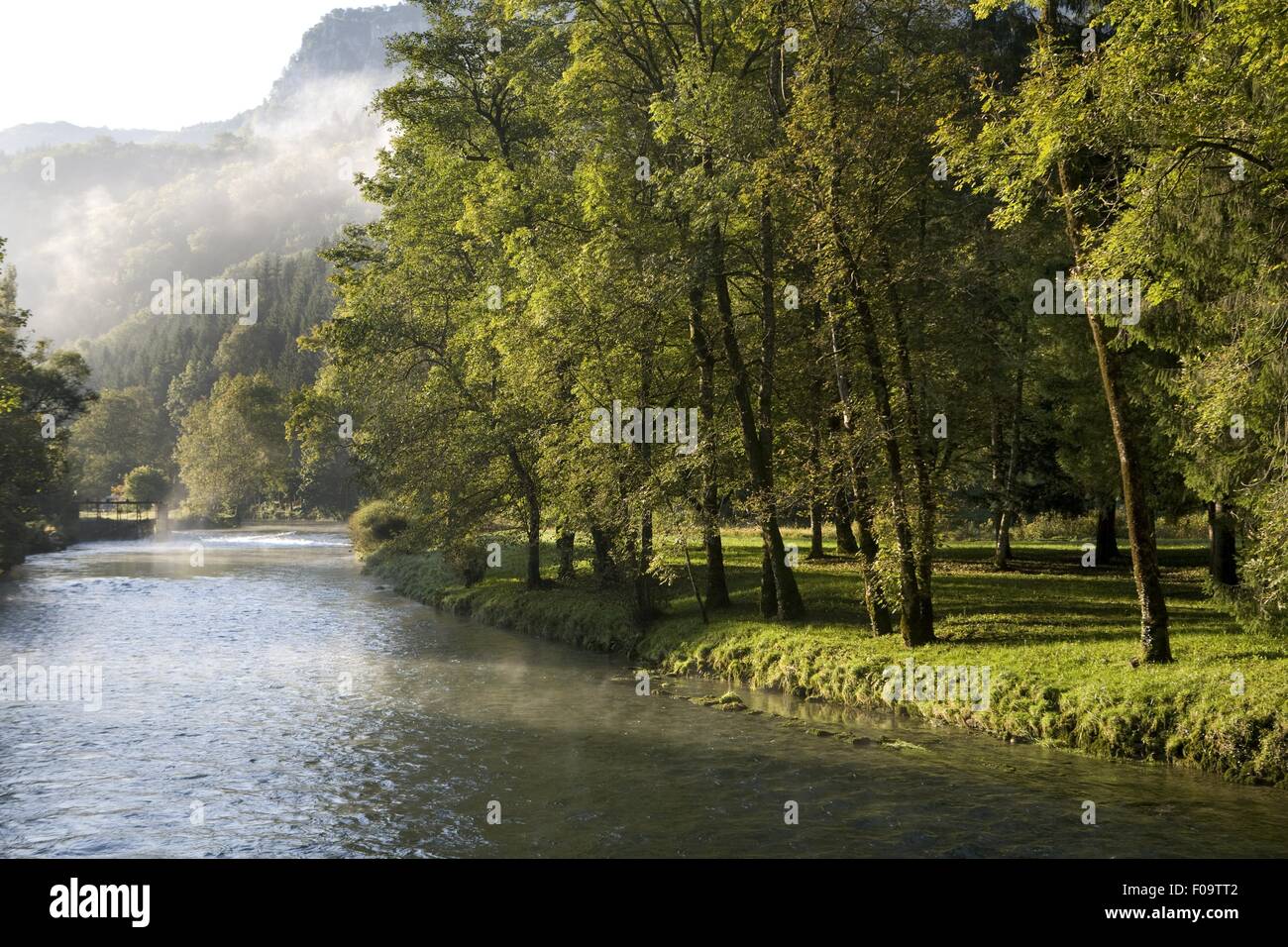 View of Loue river with fog near the village of Lods, Franche-Comte, France Stock Photo