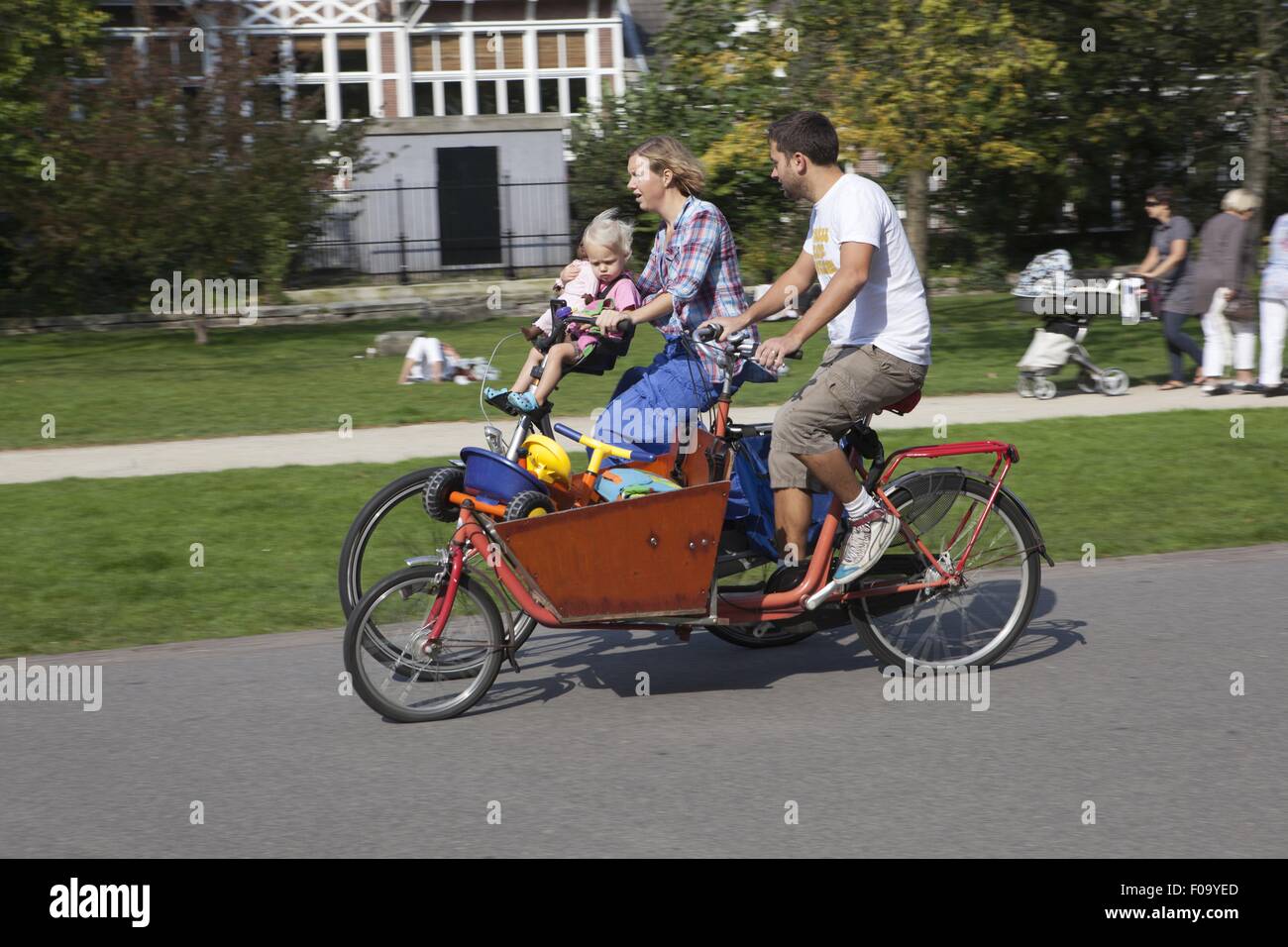 Family riding bicycle in Vondelpark, Amsterdam, Netherlands Stock Photo