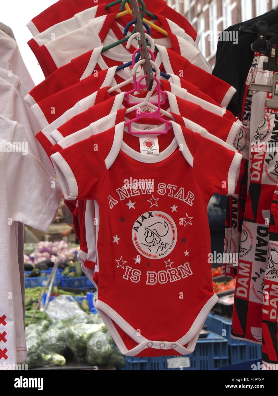 Arrangement of red baby clothes in Albert Cuyp Market, De Pijp