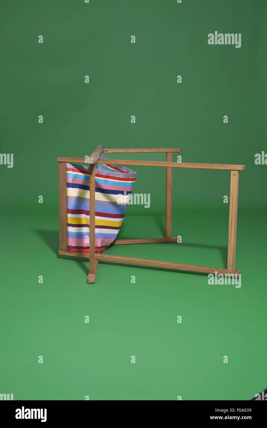 Folding Deck Chair With Stripes Pattern On Green Background