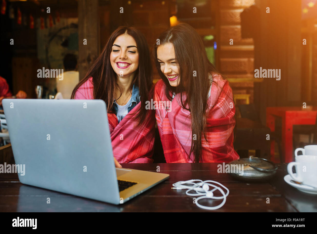 two girls watching something in laptop Stock Photo