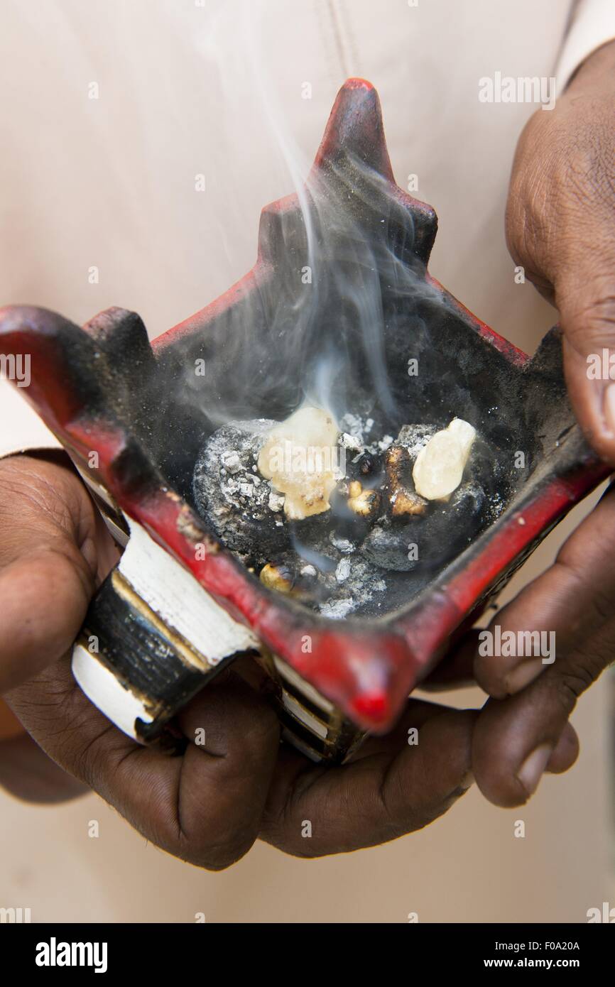 Closeup person holding incense burner at Salalah, Oman Stock Photo Alamy