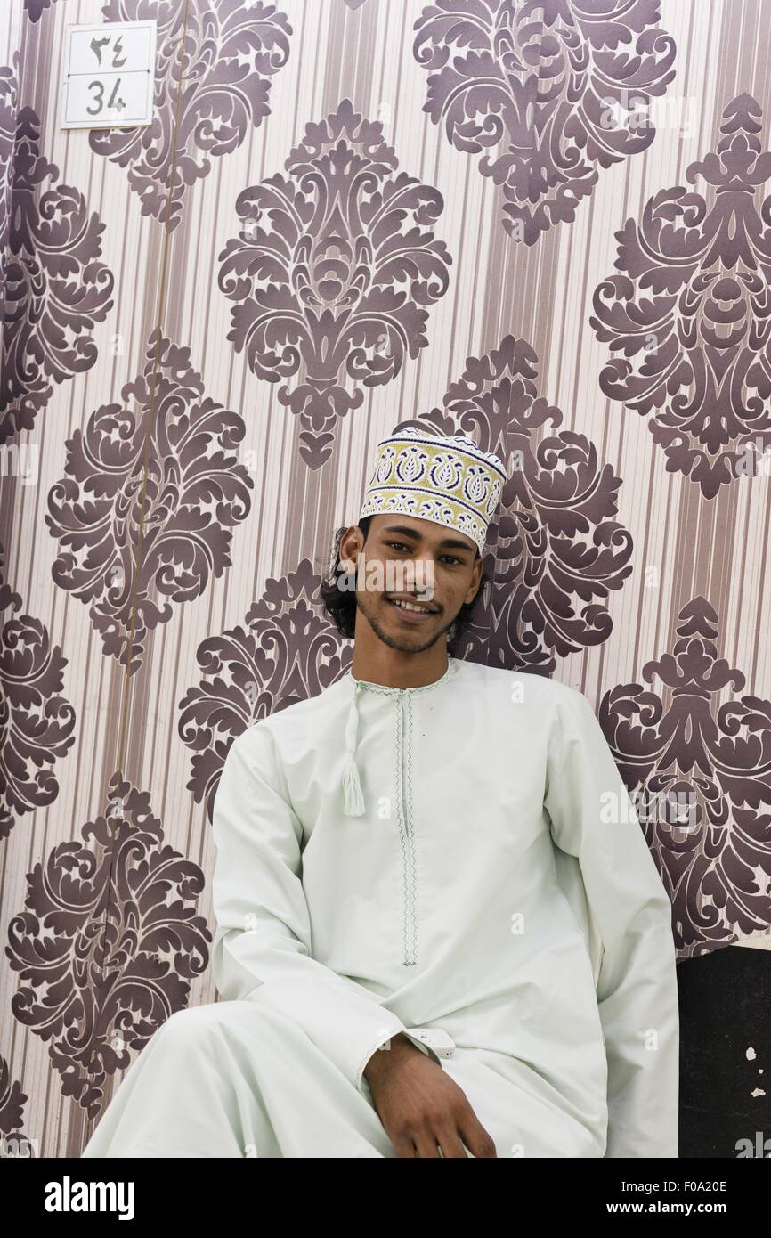 Young Omanis man wearing dishdasha smiling in Oman Stock Photo