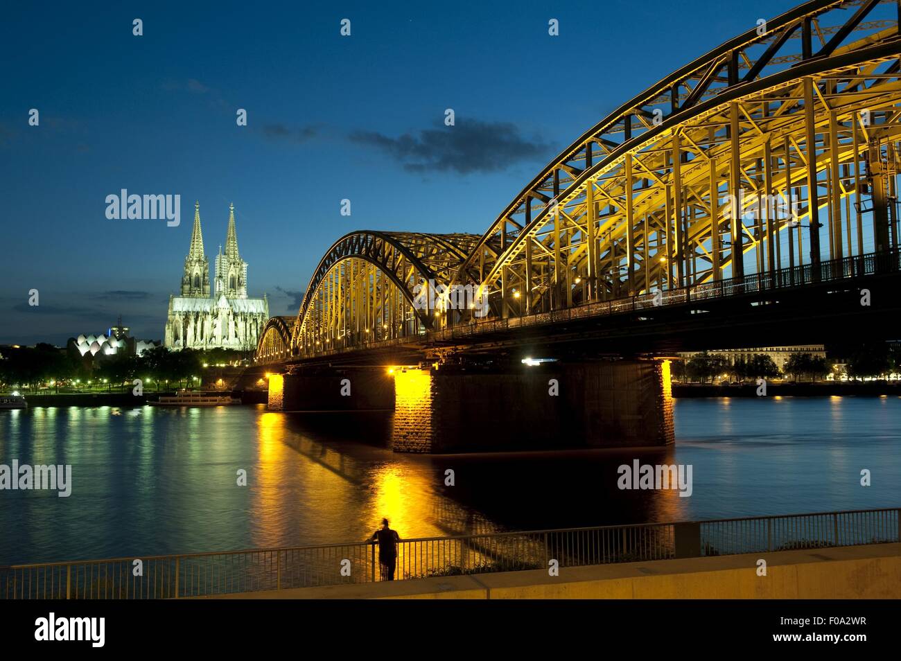 View of Rhine, Hohenzollern bridge and Cologne Cathedral at night in Cologne, Germany Stock Photo