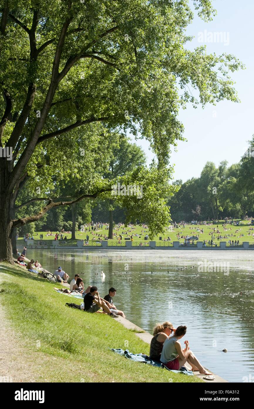 People sitting at Aachener Weiher in Belgian Quarter, Cologne, Germany Stock Photo