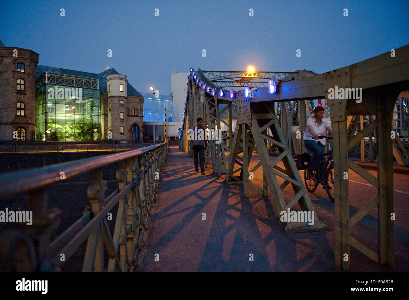 People walking on bridge in front of Stollwerk Chocolate Museum, Cologne, Germany Stock Photo