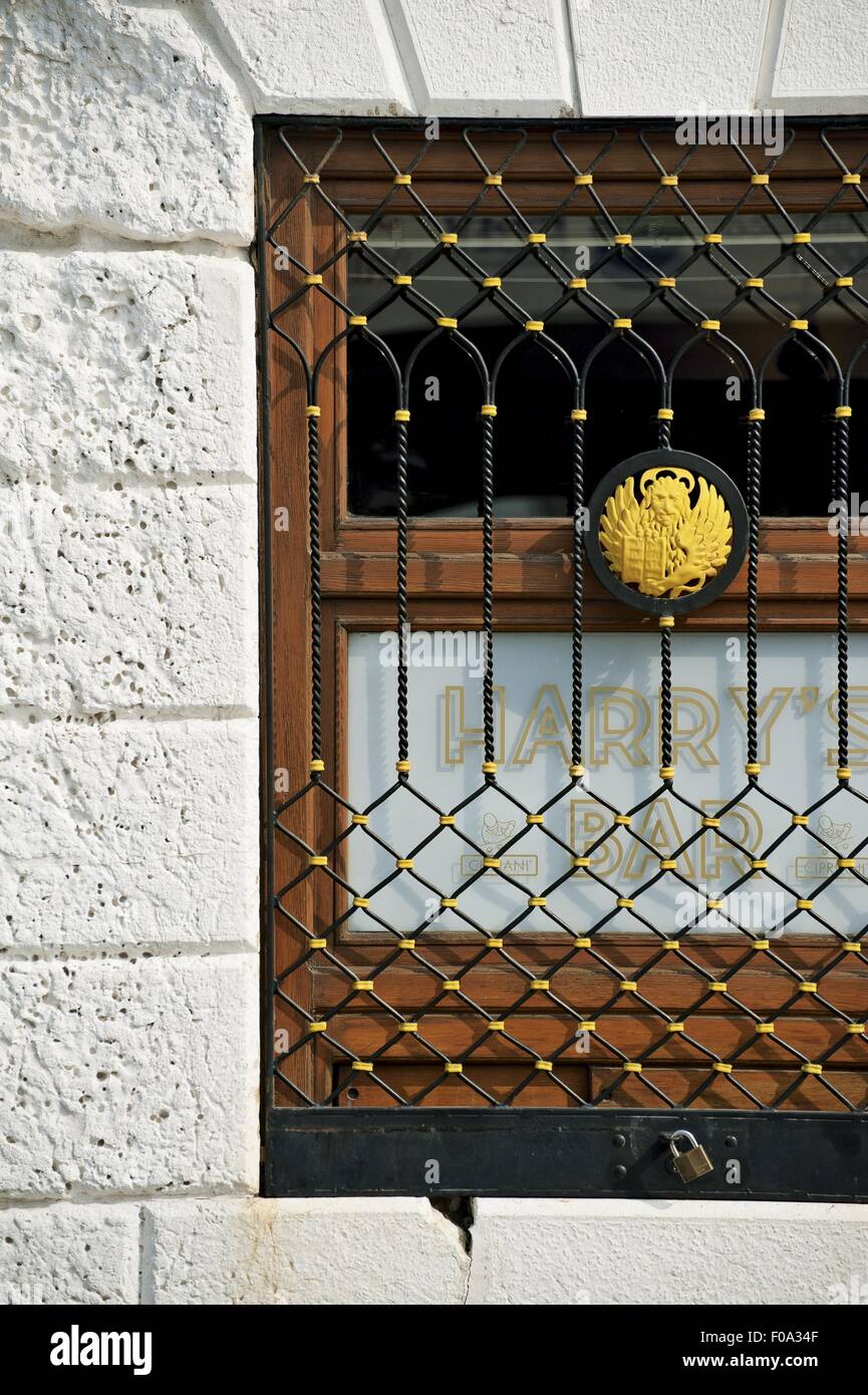 Close-up of lattice window of Harry's bar, Venice, Italy Stock Photo