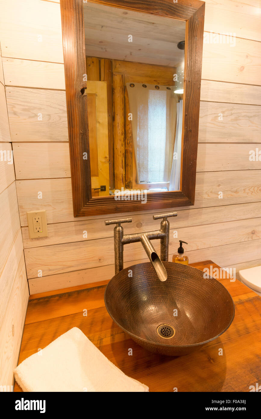 Artisan bathroom sink in a log cabin at the Minam River Lodge in Oregon's Wallowa Mountains. Stock Photo