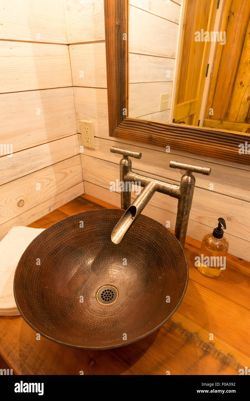 Artisan bathroom sink in a log cabin at the Minam River Lodge in Oregon's Wallowa Mountains. Stock Photo