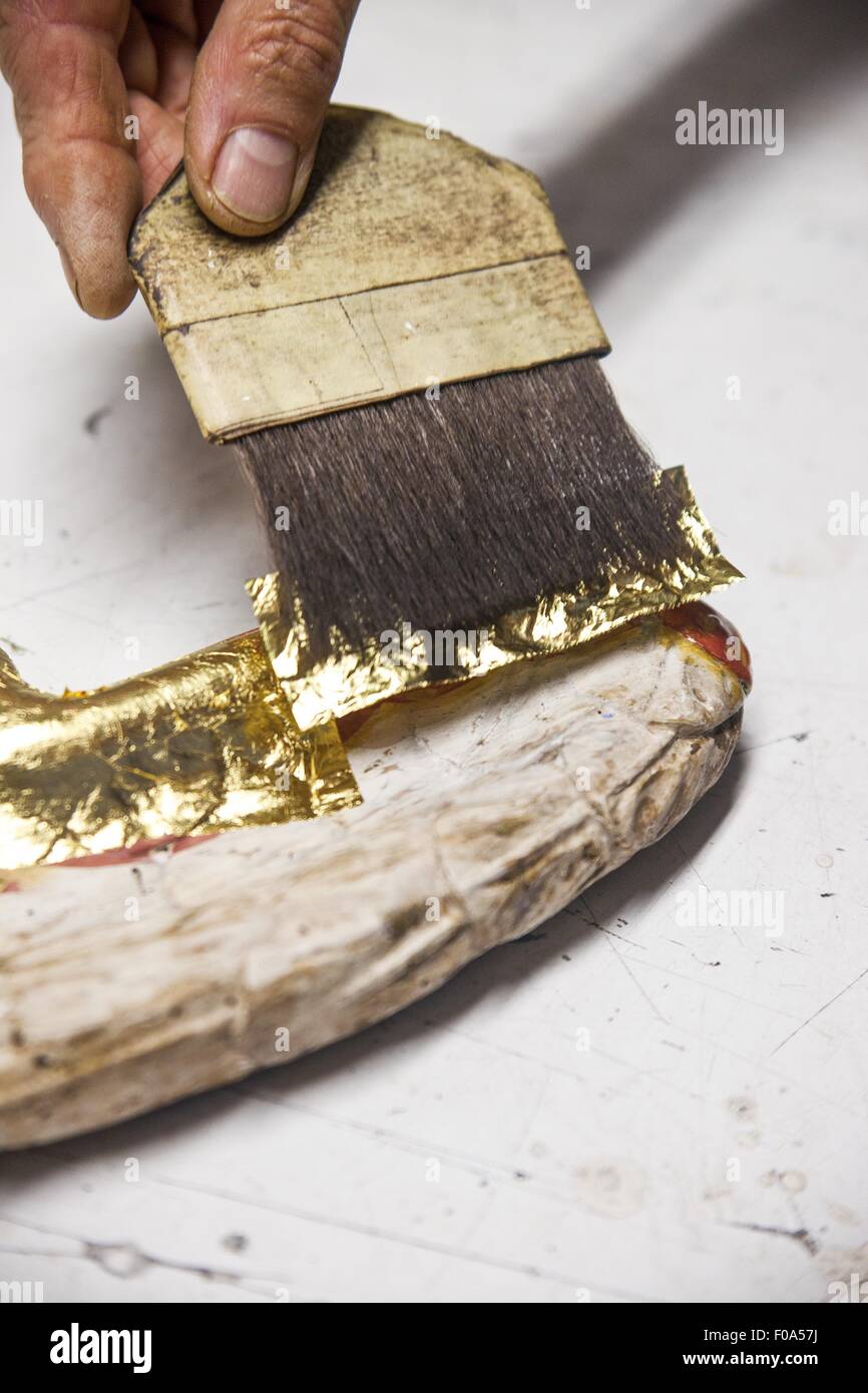 Restorating of Angel wing with gold plating Stock Photo