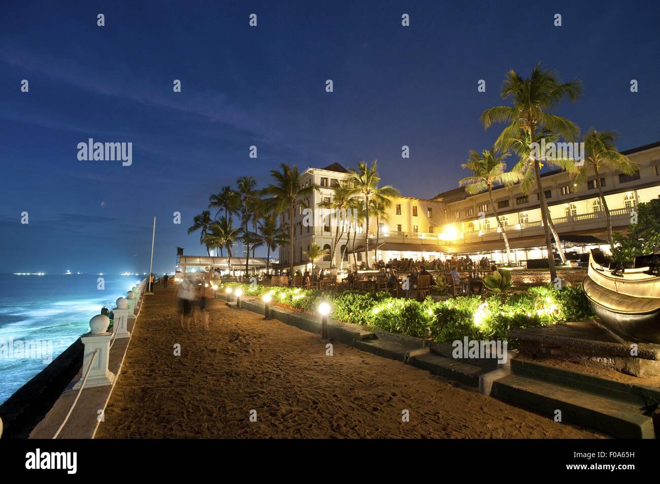 Illuminated Galle Face Hotel Promenade and Indian Ocean at night, Colombo, Sri Lanka Stock Photo