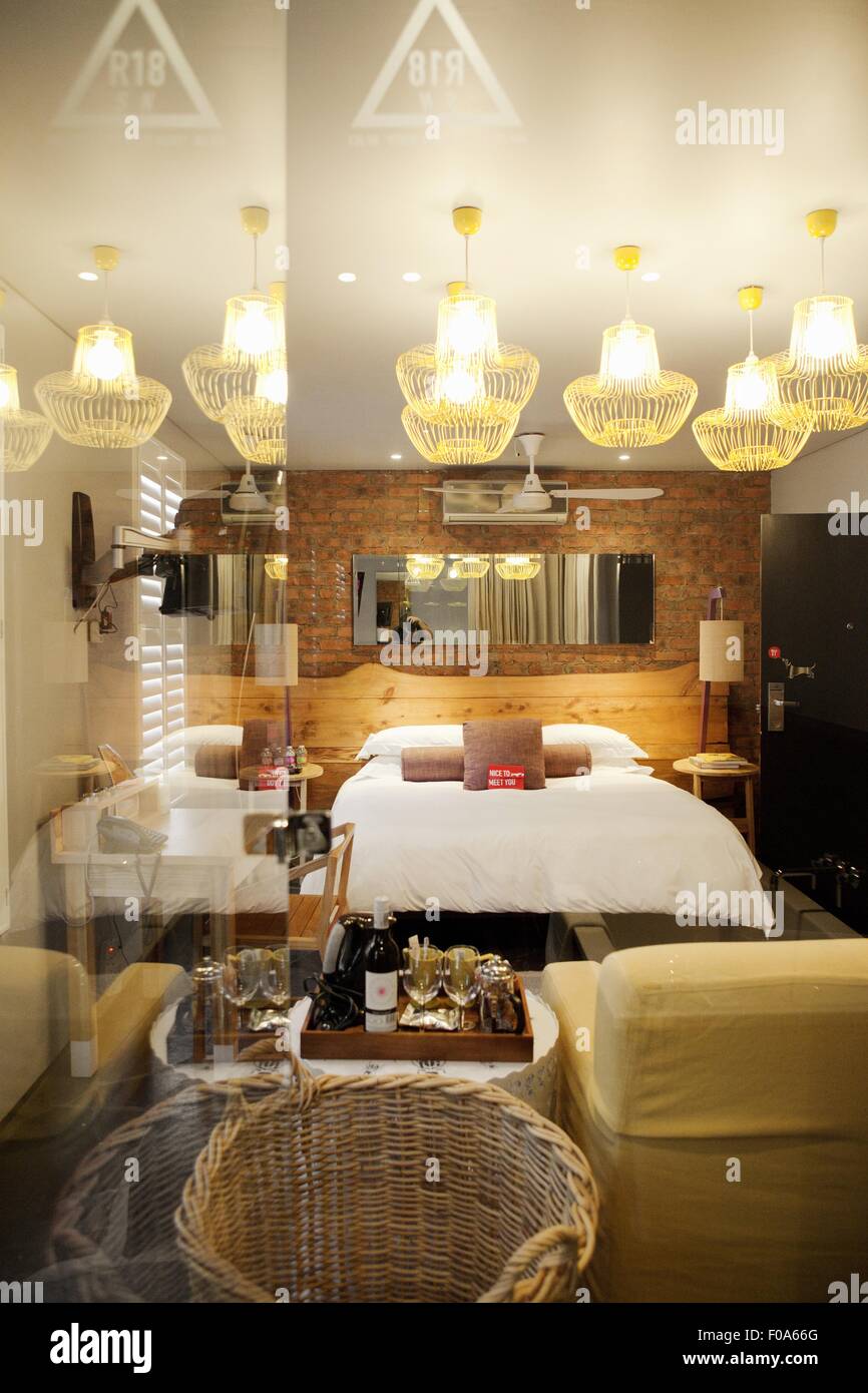 Room with double bed and chandelier in Concierge Hotel in Durban, South