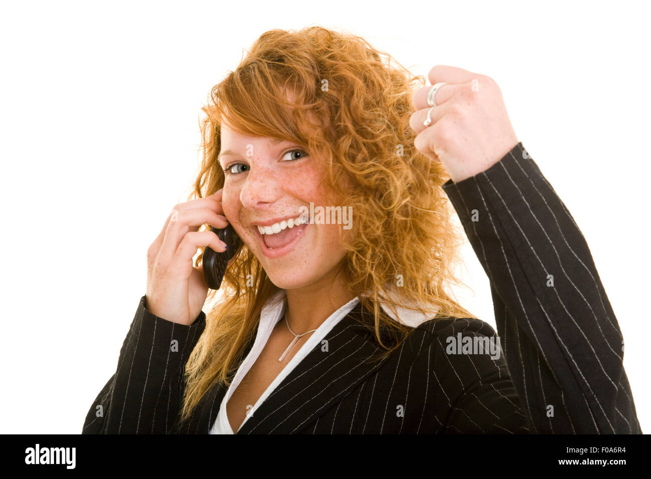 Young bussines woman with red hair cheering on cell phone Stock Photo