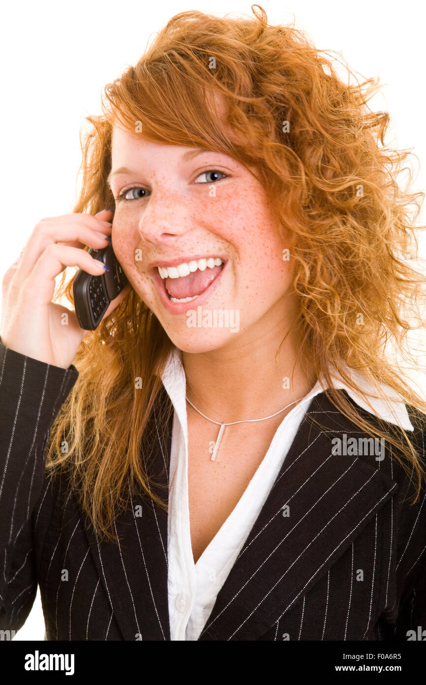 Happy business woman with red hair on her cell phone Stock Photo