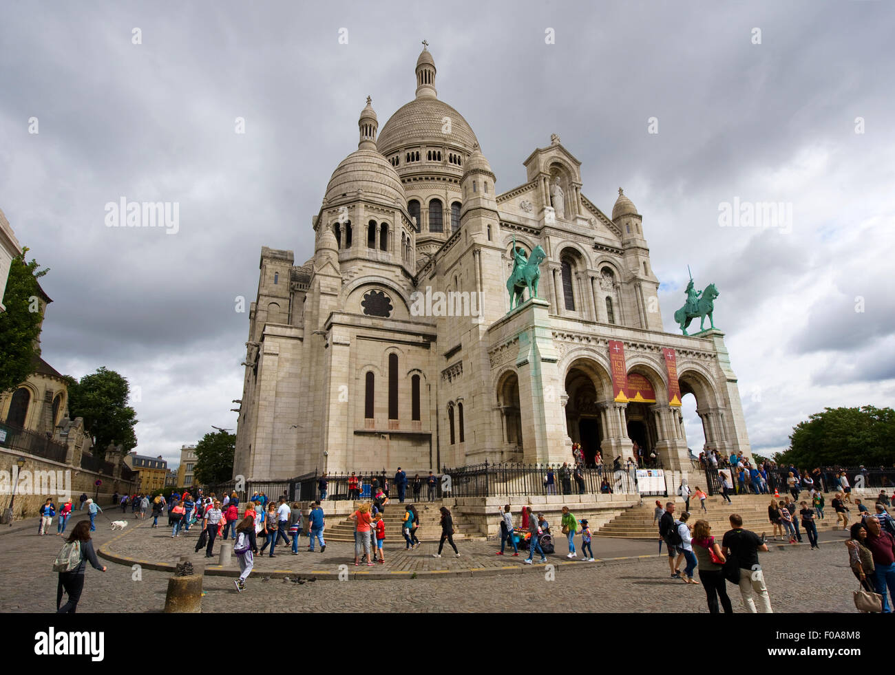 PARIS, FRANCE - JULY 27, 2015: Tourists are visiting the Sacre Coeur cathedral in Montmarte in Paris in France Stock Photo
