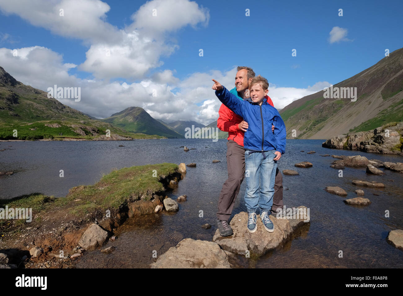 A father and son enjoy the view at Wastwater in the Lake District Cumbria, UK Stock Photo