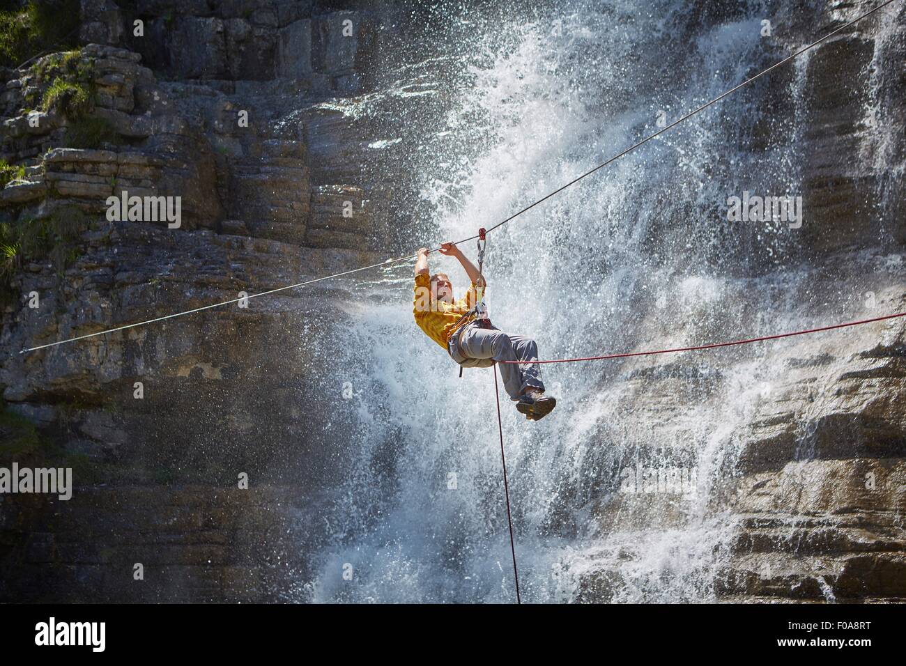 Man rappelling waterfall, Ehrwald, Tyrol, Austria Stock Photo