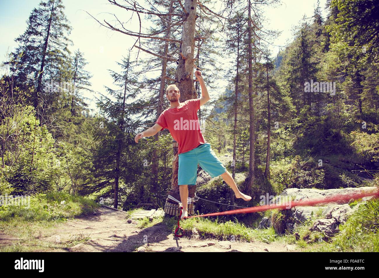 Man balancing on rope, Ehrwald, Tyrol, Austria Stock Photo