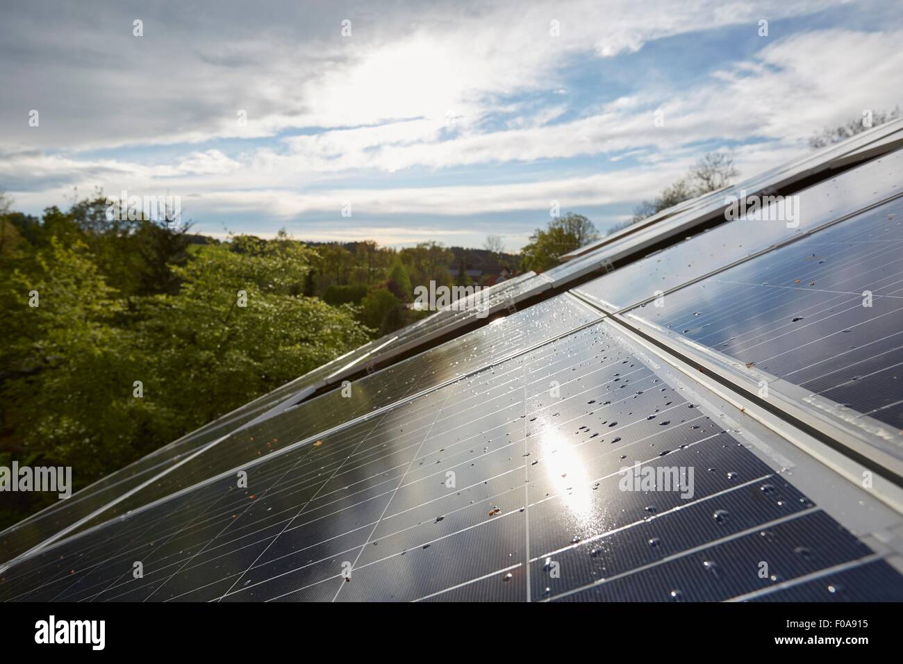 Elevated close up of sunlit solar panels on house roof Stock Photo