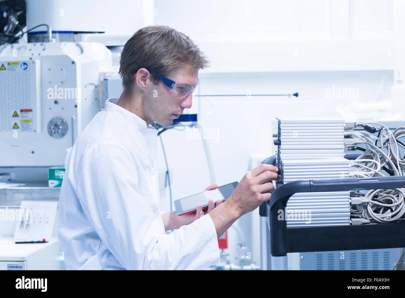 Male scientist adjusting control panel in laboratory Stock Photo