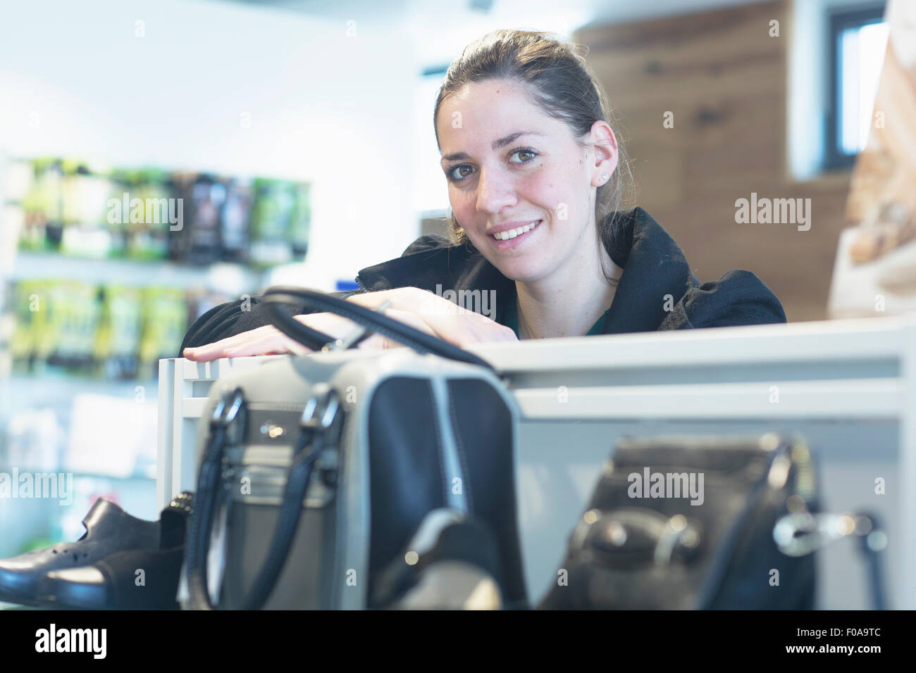 Portrait of female sales assistant in shoe shop Stock Photo