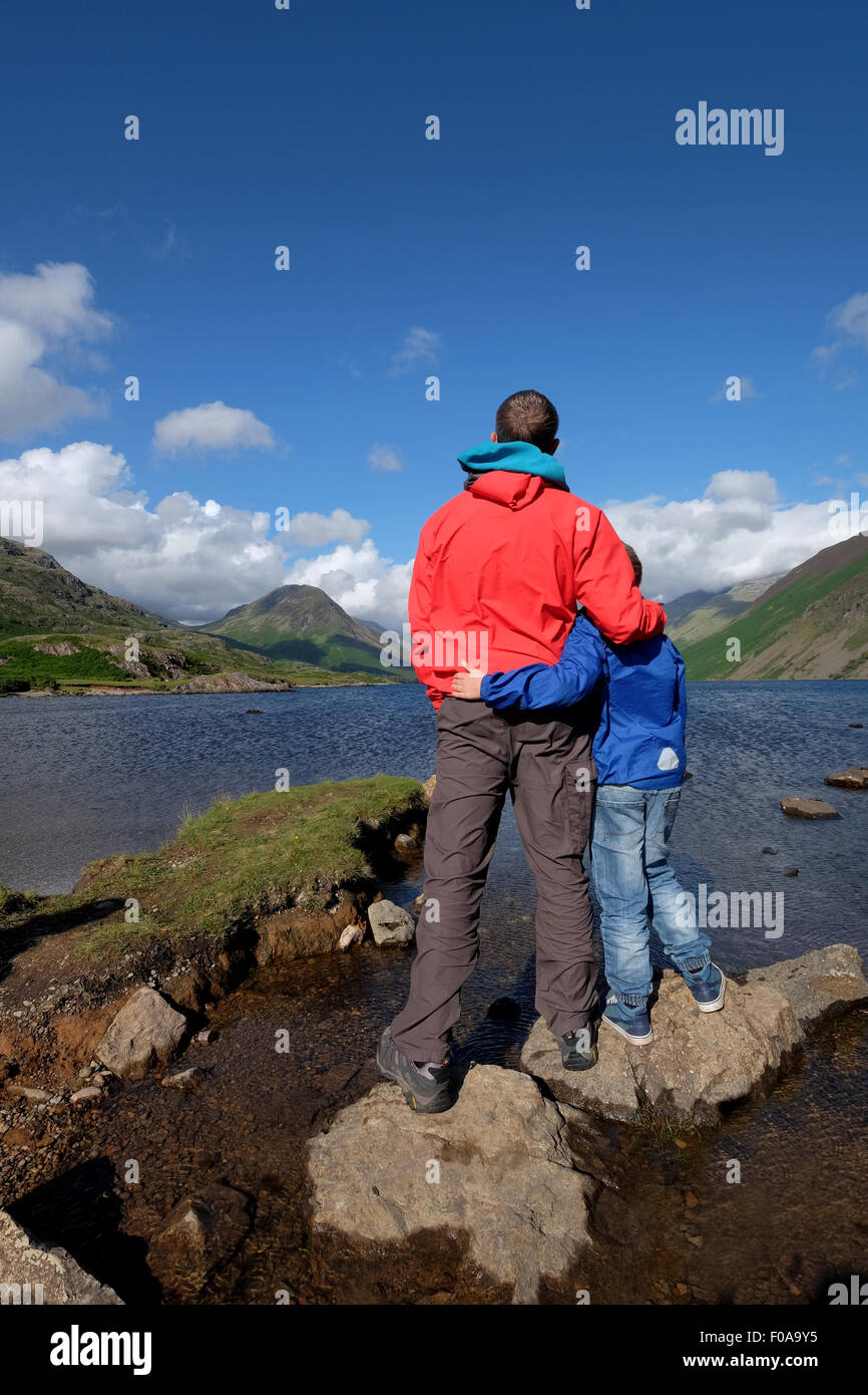 A father and son enjoy the view at Wastwater in the Lake District Cumbria, UK Stock Photo