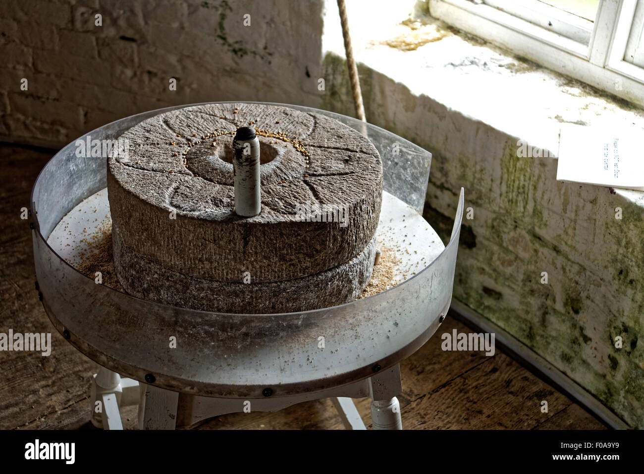 Hand grinding wheel in windmill Stock Photo
