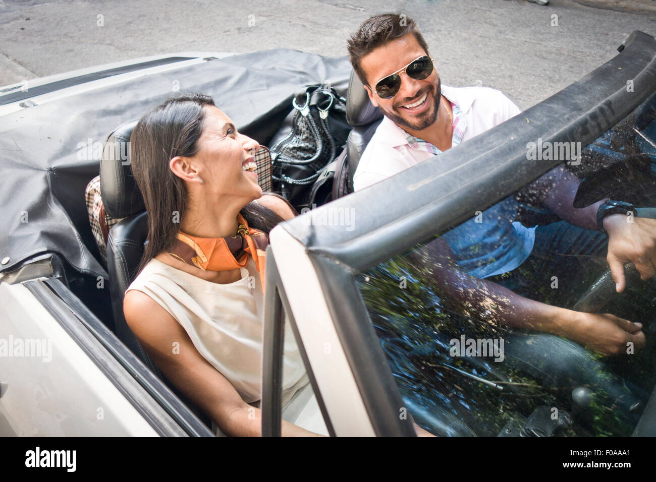 Mid adult couple in convertible car, elevated view Stock Photo