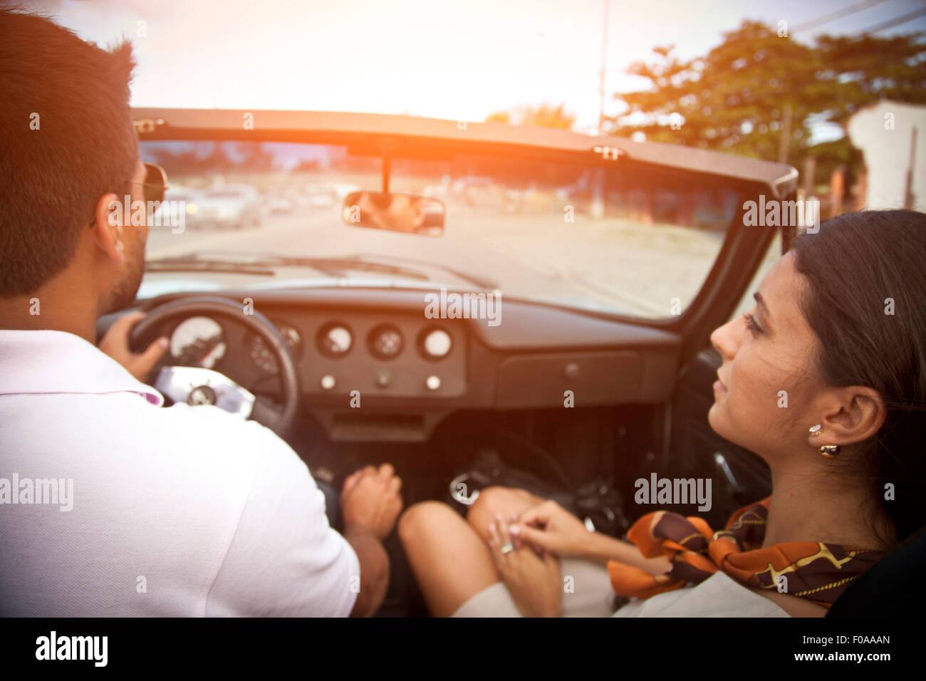 Mid adult couple in convertible car, rear view Stock Photo