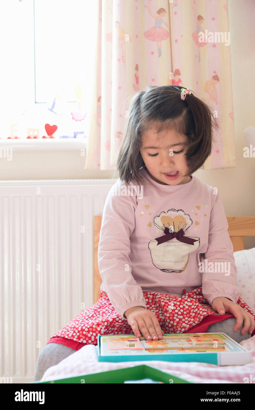 Young girl doing puzzle Stock Photo