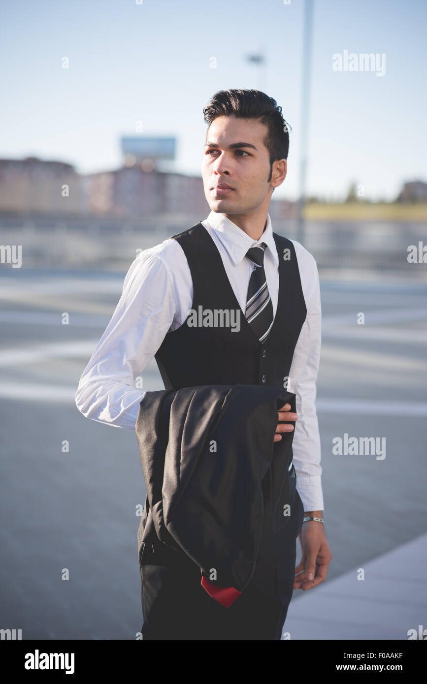 Young businessman carrying jacket Stock Photo