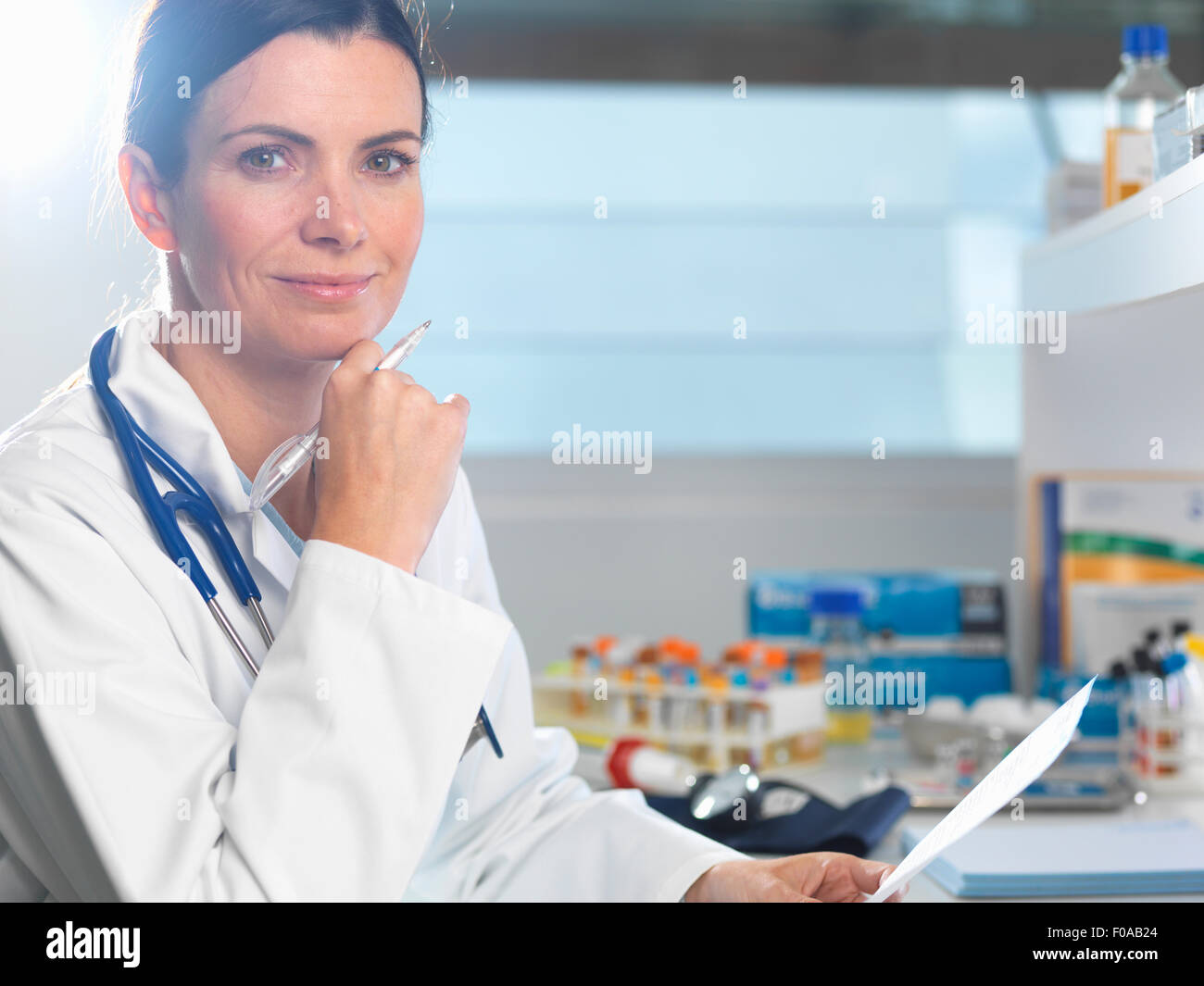 Doctor at desk reviewing patient's notes Stock Photo