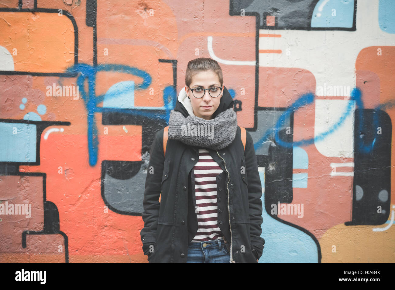 Teenager by graffiti wall Stock Photo