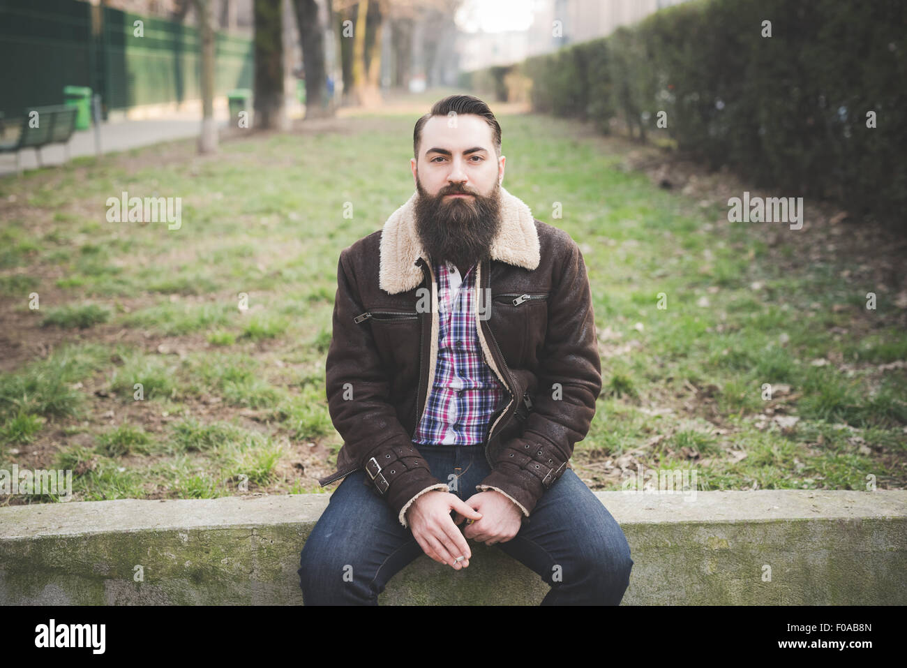 Young bearded man in park Stock Photo