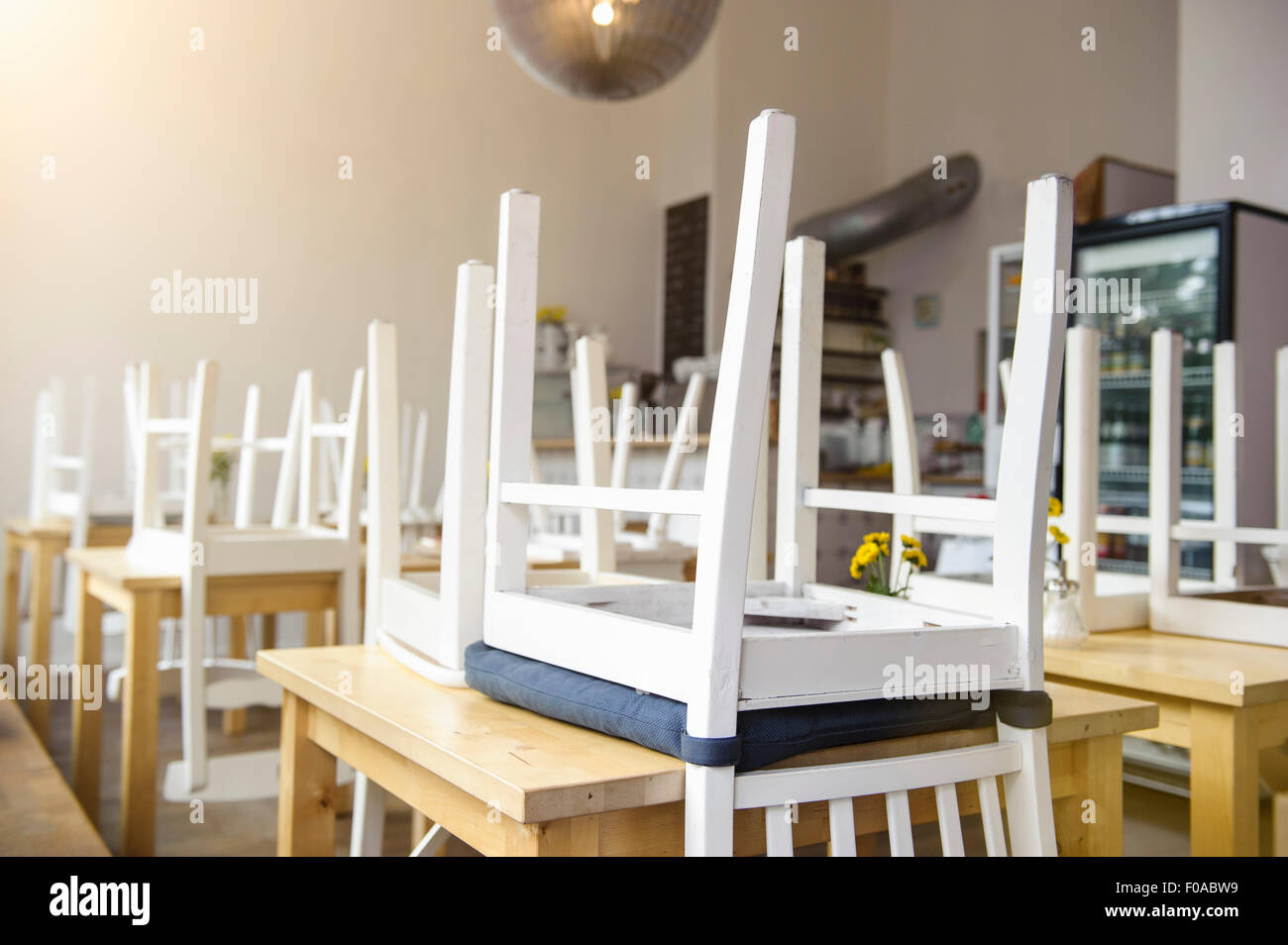 Upside down chairs on table in cafe Stock Photo