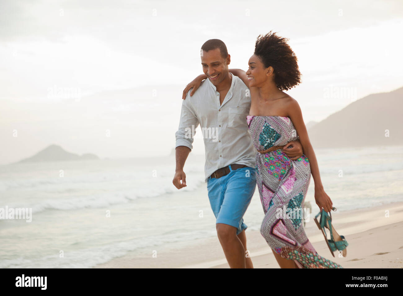 Romantic couple strolling on beach, Rio De Janeiro, Brazil Stock Photo