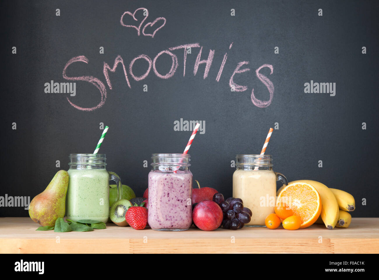 Still life of three fresh smoothies in front of blackboard Stock Photo