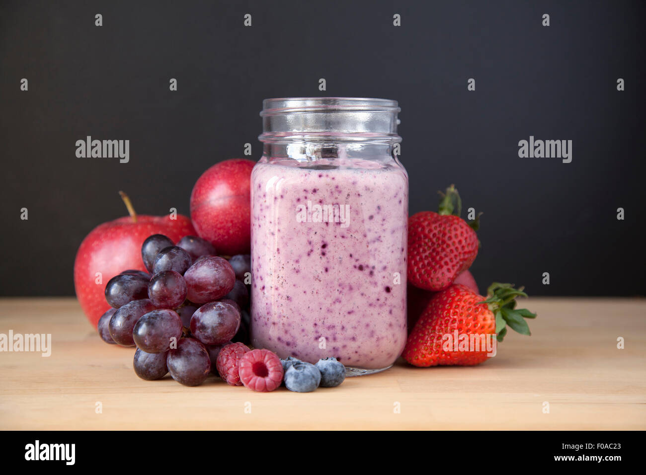Still life of fresh grape, apple and berry smoothie Stock Photo