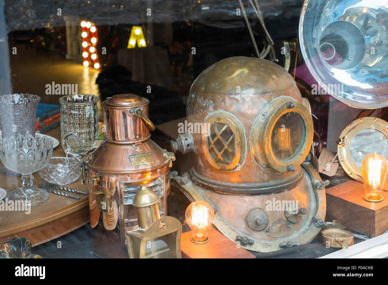 Antique deep sea diving helmet in a shop window at Fowey, Cornwall, England, UK Stock Photo