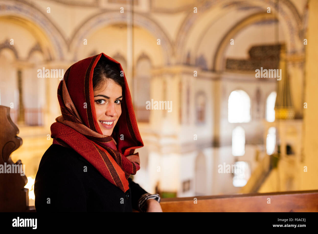 Portrait of young woman in mosque, wearing headscarf, Istanbul, Turkey
