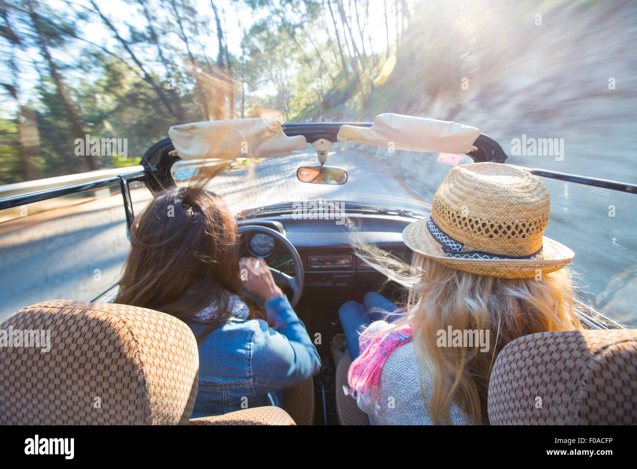 Two mature women in convertible car, rear view Stock Photo