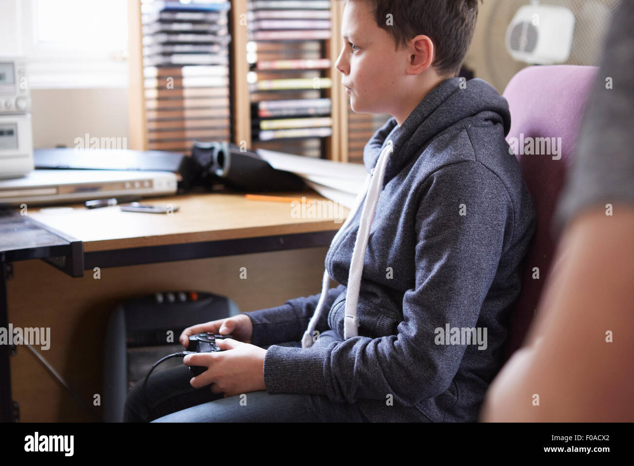 Boy using control for computer game Stock Photo - Alamy